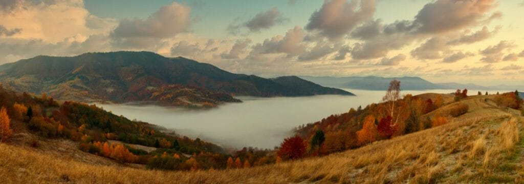 Ukraine. A magical autumn sunrise, with mist creeping over valleys, over mountain formations far from civilization. Synevyr pass located in the Carpathian mountains.